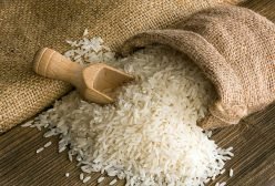 White uncooked rice in small burlap sack